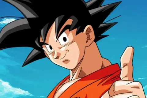 Goku, con su icónica ropa naranja y pulgar arriba, celebra el Goku Day bajo un cielo azul con nubes. ¡Un día para recordar!