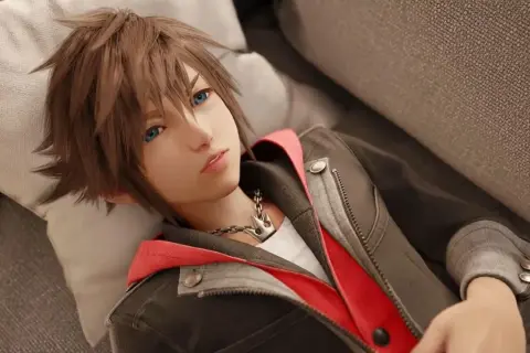 Sora, protagonista de Kingdom Hearts IV, descansa en un sofá, con su icónica cadena de corona visible.