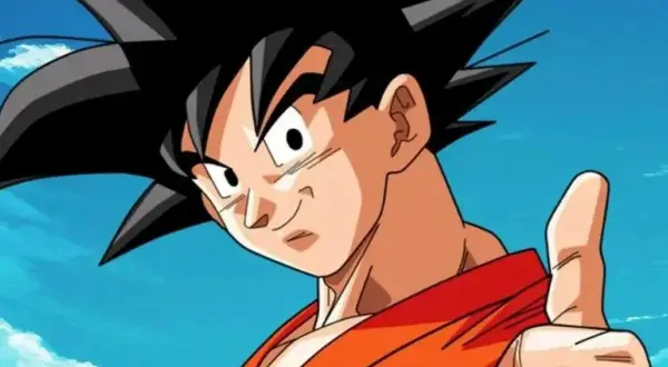 Goku, con su icónica ropa naranja y pulgar arriba, celebra el Goku Day bajo un cielo azul con nubes. ¡Un día para recordar!