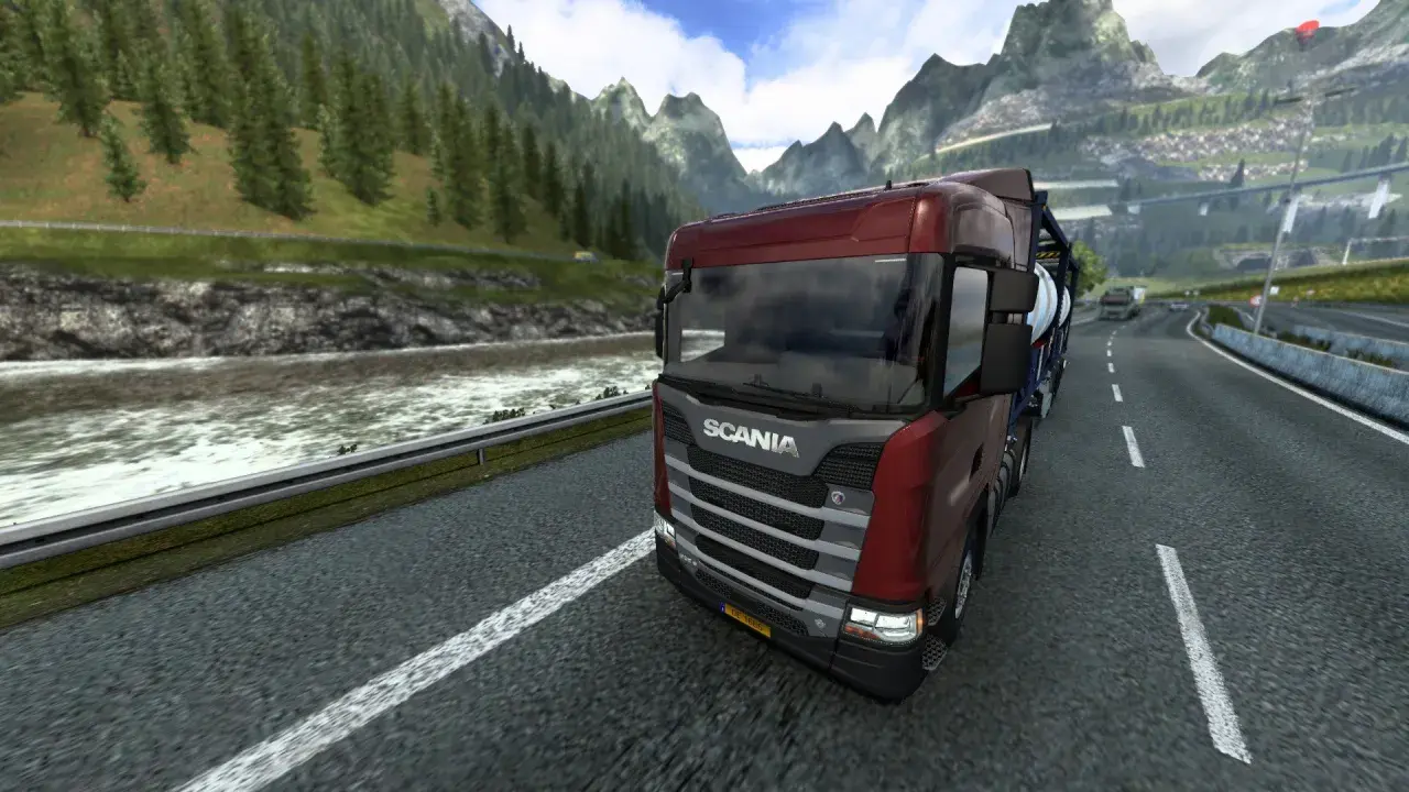Camión Scania rojo en una carretera montañosa, disfrutando de la experiencia de Euro Truck Simulator 2 en PS5.