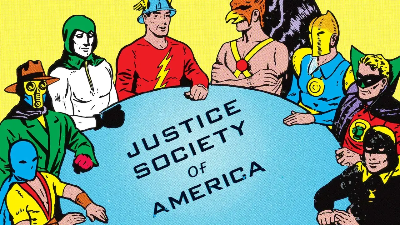 Miembros de la Sociedad de la Justicia de Am&eacute;rica se re&uacute;nen alrededor de una mesa azul.